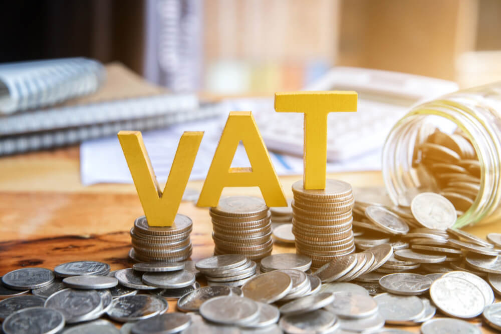 vat-concept-word-vat-with-stacked-coins-there-is-notebook-calculator-desk
